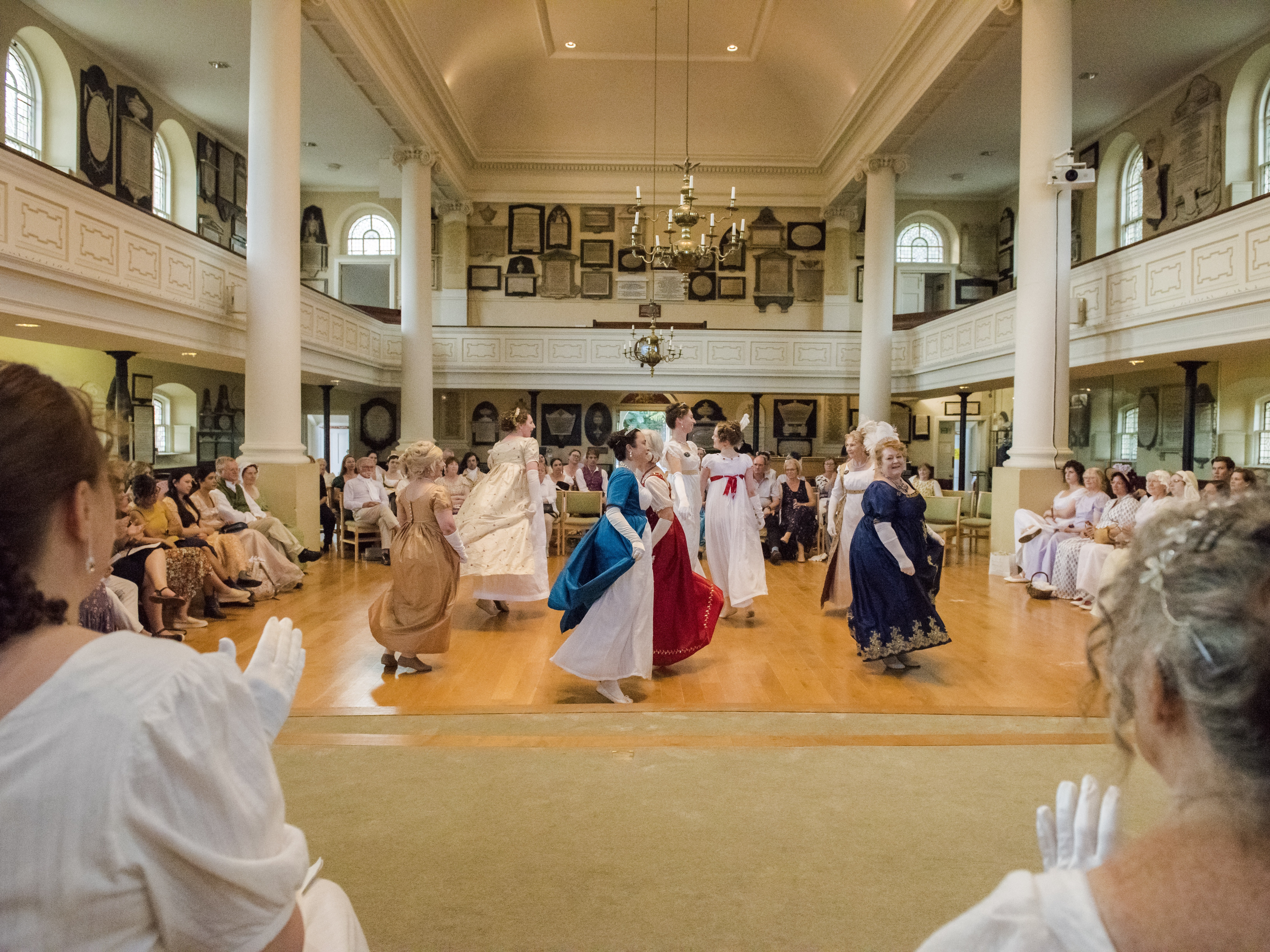 caption: Dancers perform in St Swithins Church, Bath, at the Jane Austen Festival, 2023.