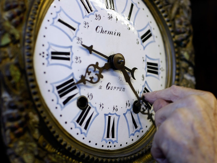 caption: A man adjusts his clock during daylight saving time. The Norwegian island of Sommaroy, which sits north of the Arctic Circle, enjoys  unending sunlight from May 18 to July 26, and its residents argue that time is meaningless there.