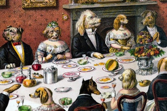 A group of well-dressed dogs take part in a banquet.