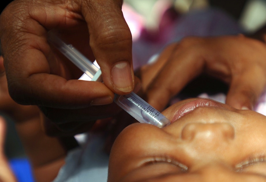 caption: A nurse vaccinates a baby against rotavirus, a deadly form of diarrhea.