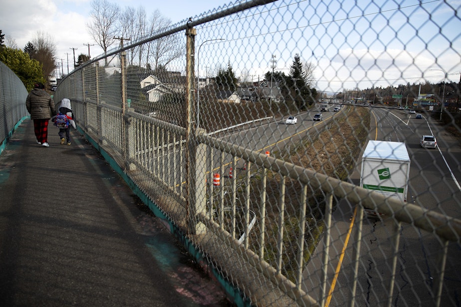 caption: Pedestrians cross Highway 99 near the intersection of South Henderson Street on Thursday, March 2, 2023, in the South Park neighborhood of Seattle.
