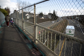 caption: Pedestrians cross Highway 99 near the intersection of South Henderson Street on Thursday, March 2, 2023, in the South Park neighborhood of Seattle. 