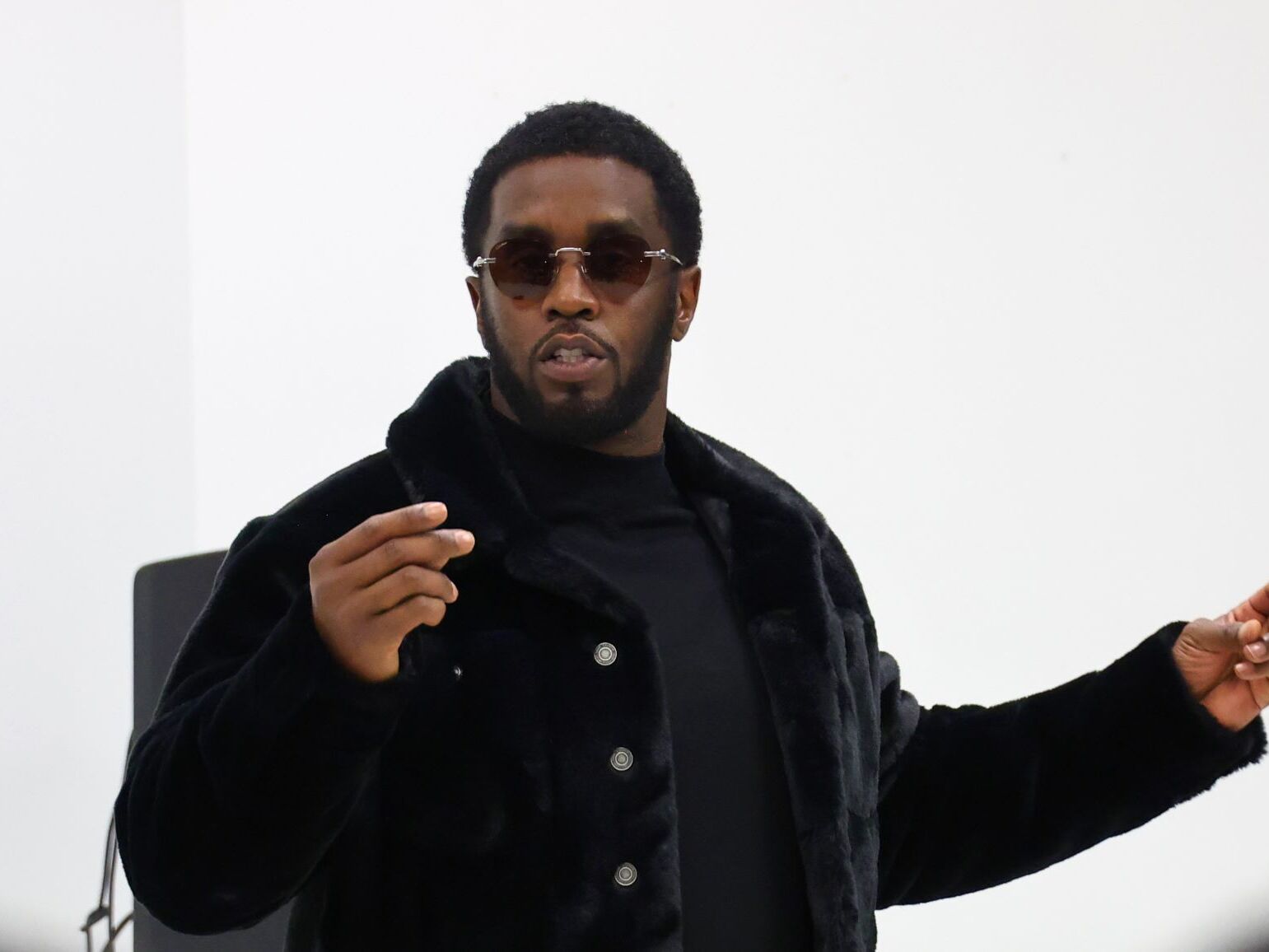 caption: Sean “Diddy” Combs appears before students at his Capital Preparatory School in the Bronx on Oct. 18, 2022.