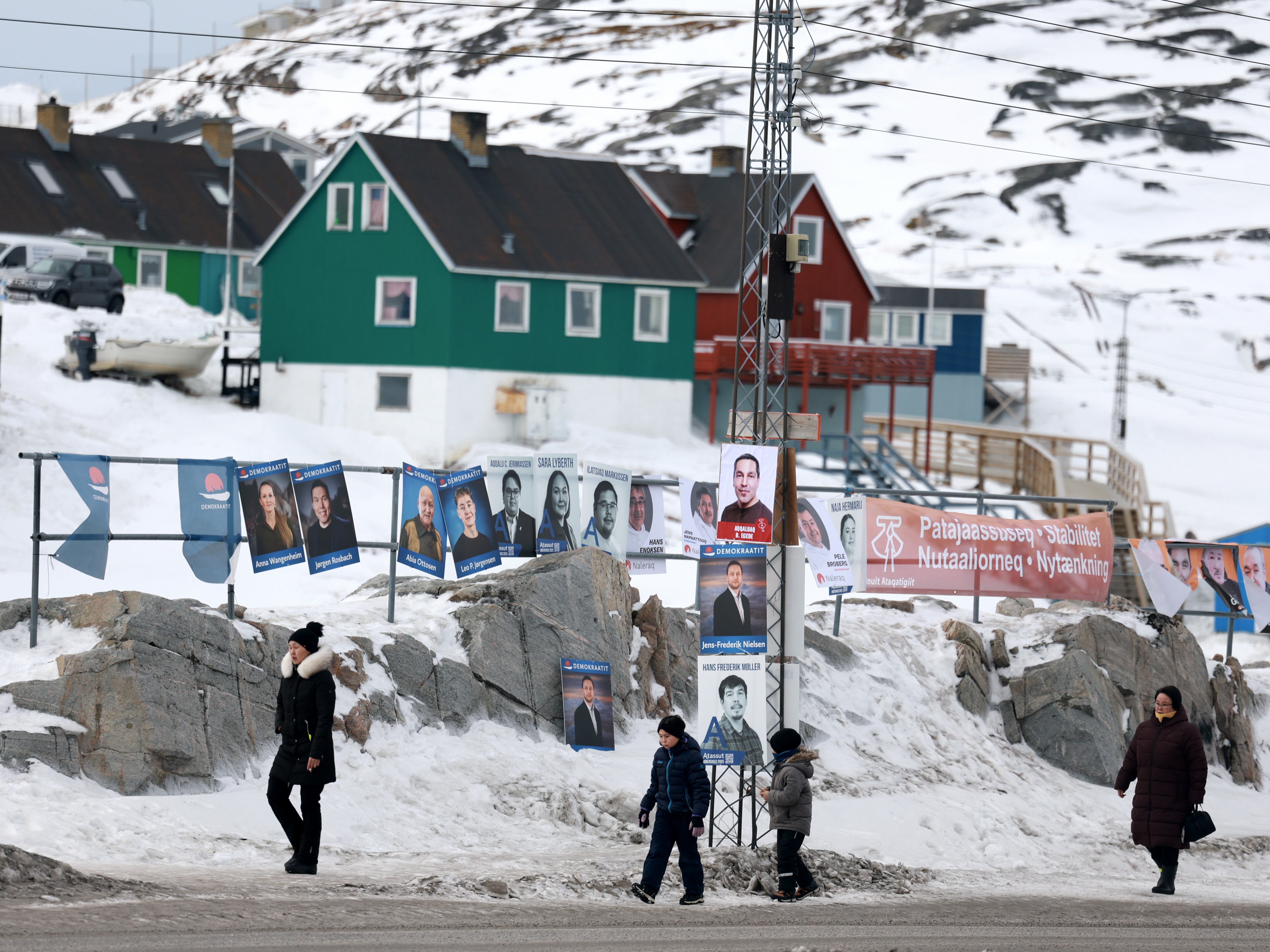 caption: Campaign posters hang outside a polling station ahead of Greenland's March 11 election, in Ilulissat, Greenland. The island will elect the 31 members of its parliament, called the Inatsisartut. Greenland was due to hold elections by April 6, but Prime Minister Mute Egede called for an early vote amid the geopolitical tensions stoked by President  Trump's vow to take control of the autonomous Danish territory.