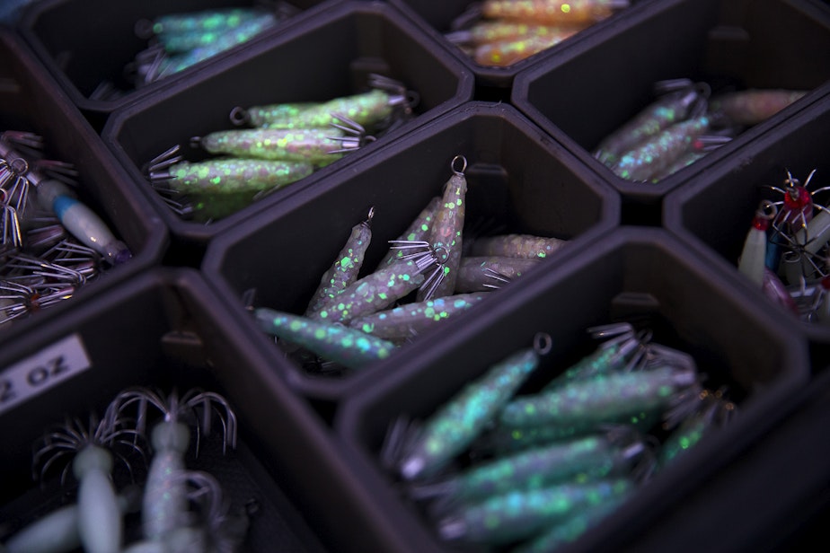 caption: Various glow in the dark jigs for catching squid made by Curtis Alm are shown for sale on Friday, November 17, 2023, at Les Davis Pier in Tacoma. 