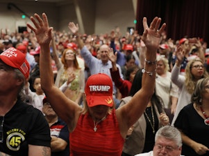 caption: People pray during a "Evangelicals for Trump" campaign event in 2020.