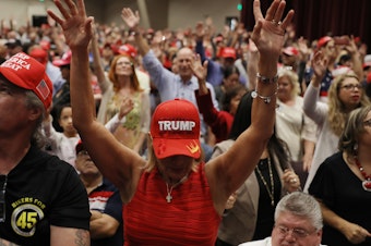 caption: People pray during a "Evangelicals for Trump" campaign event in 2020.