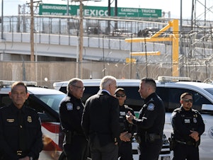 caption: President Biden speaks with U.S. Customs and Border Protection police at the Bridge of the Americas border crossing between Mexico and the U.S. in El Paso, Texas, on Sunday.