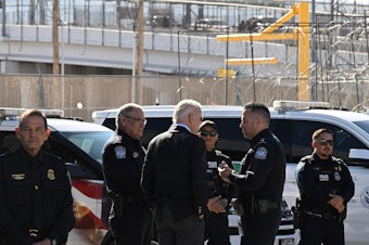 caption: President Biden speaks with U.S. Customs and Border Protection police at the Bridge of the Americas border crossing between Mexico and the U.S. in El Paso, Texas, on Sunday.
