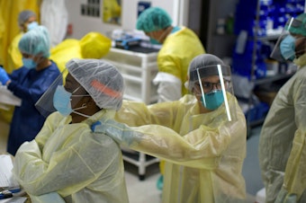 caption: Health care workers at the Covid-19 Unit at United Memorial Medical Center in Houston on July 2.