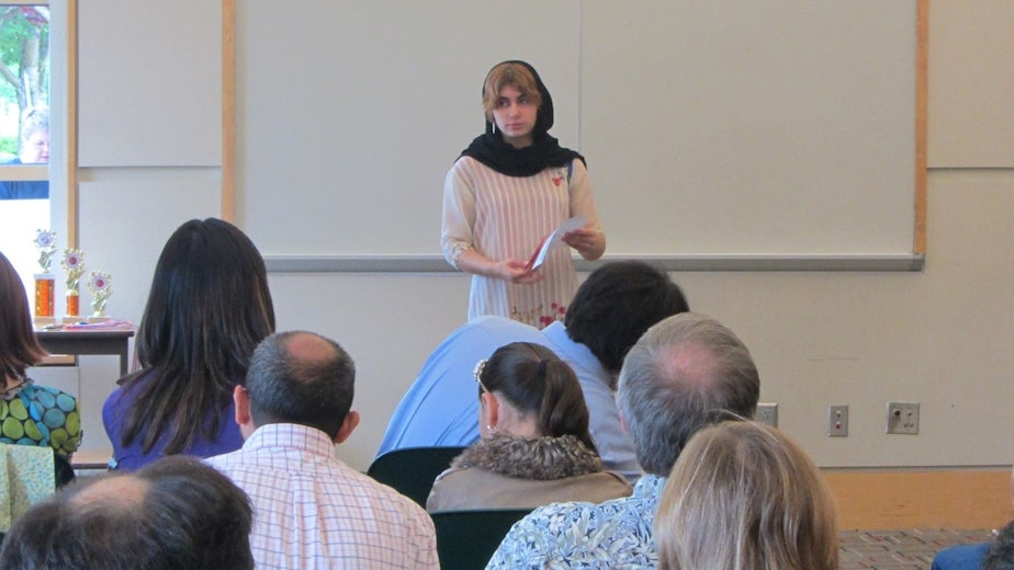 caption: David Reed’s daughter, Alia Reed, speaks in front a group during a speech contest. She gained confidence in public speaking through participating in the Toastmasters Gavel Club program.
