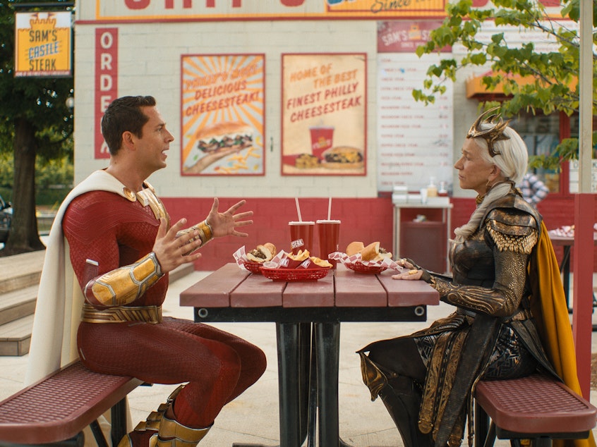 caption: "Forget Pat's, forget Geno's. Jim's. Jim's in the best cheesesteak in Philly." Shazam (Zachary Levi) and Hespera (Helen Mirren) have a sit-down.
