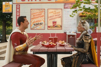 caption: "Forget Pat's, forget Geno's. Jim's. Jim's in the best cheesesteak in Philly." Shazam (Zachary Levi) and Hespera (Helen Mirren) have a sit-down.