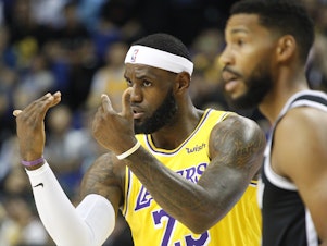 caption: Los Angeles Lakers' Lebron James gestures during a preseason NBA game against the Brooklyn Nets in Shanghai, China, Thursday.  All of the usual media sessions surrounding the Lakers-Nets preseason game in Shanghai on Thursday — including a scheduled news conference from NBA Commissioner Adam Silver and postgame news conferences with the teams — were canceled.