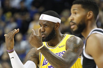 caption: Los Angeles Lakers' Lebron James gestures during a preseason NBA game against the Brooklyn Nets in Shanghai, China, Thursday.  All of the usual media sessions surrounding the Lakers-Nets preseason game in Shanghai on Thursday — including a scheduled news conference from NBA Commissioner Adam Silver and postgame news conferences with the teams — were canceled.