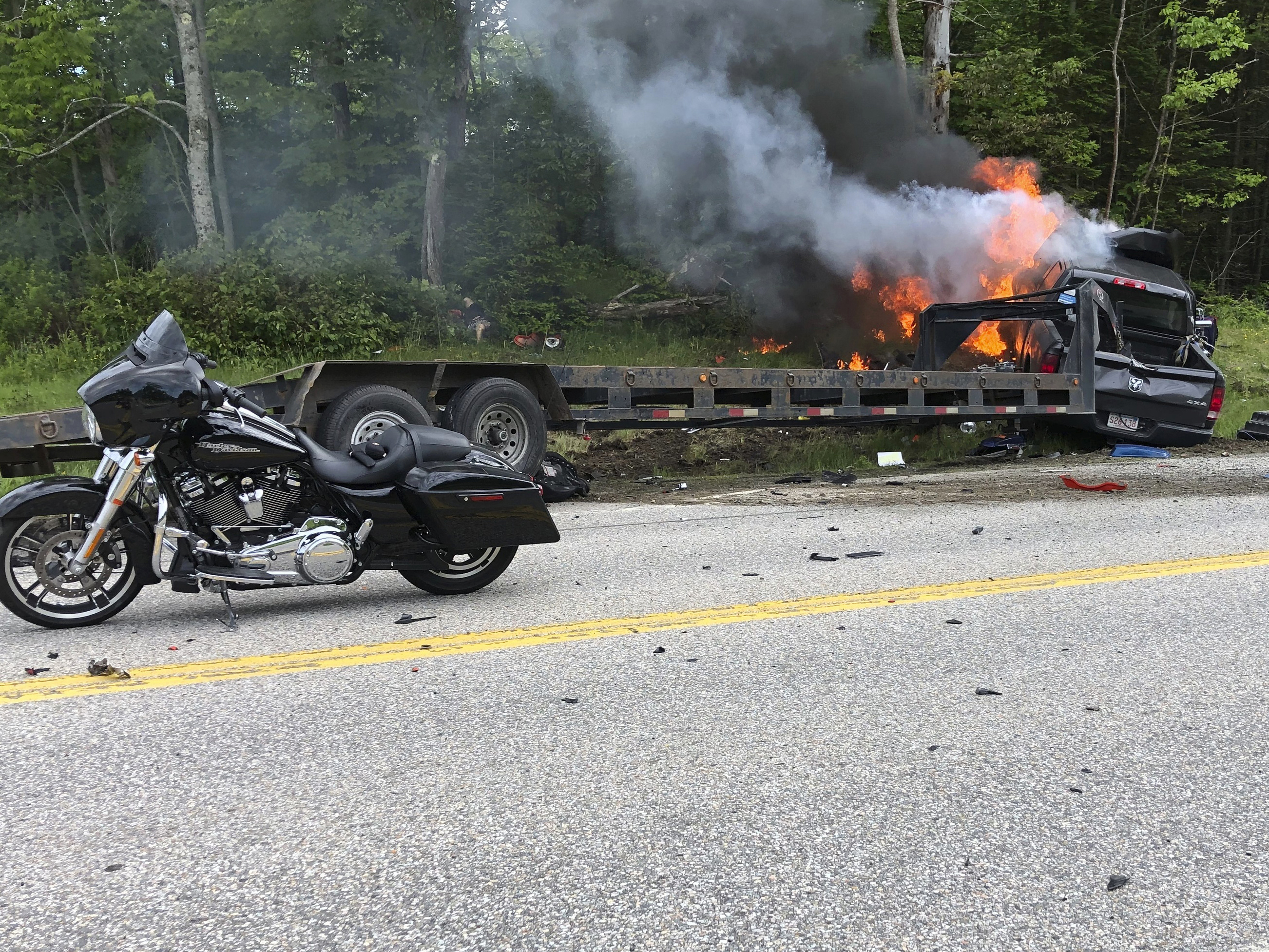 caption: This photo provided by Miranda Thompson shows the scene where several motorcycles and a pickup truck collided on a rural, two-lane highway Friday in Randolph, N.H.