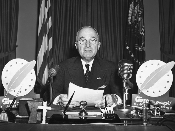 caption: President Harry S. Truman speaks during a television address from the Oval Office in 1947.