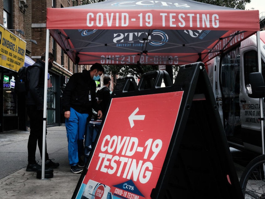 caption: A COVID-19 pop-up testing sits stands on a Manhattan street in October in New York City. On Tuesday, Pfizer released promising data about a pill to treat COVID-19.