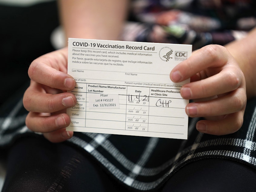 caption: 9 year-old Josie Murdoch holds her vaccination card at Chapel Hill Pediatrics and Adolescents after being innoculated with the Pfizer child COVID-19 vaccination in Chapel Hill, N.C., Thursday, Nov. 4, 2021.