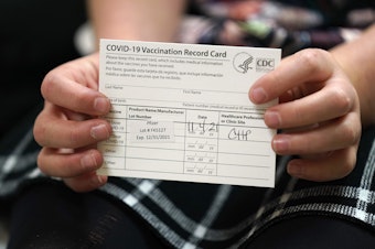 caption: 9 year-old Josie Murdoch holds her vaccination card at Chapel Hill Pediatrics and Adolescents after being innoculated with the Pfizer child COVID-19 vaccination in Chapel Hill, N.C., Thursday, Nov. 4, 2021.
