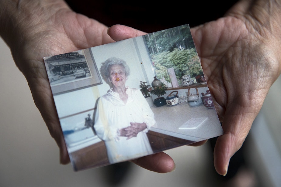 caption: Sheila Kelly holds a photograph of her mother, Helen May Kelly, on Friday, November 22, 2019, at her home in Seattle. The photo shows Helen on the Thanksgiving when she brought the mince pie to Sheila's house.