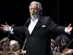 caption: Opera star Plácido Domingo, performing at a concert in Marbella, Spain on July 11.