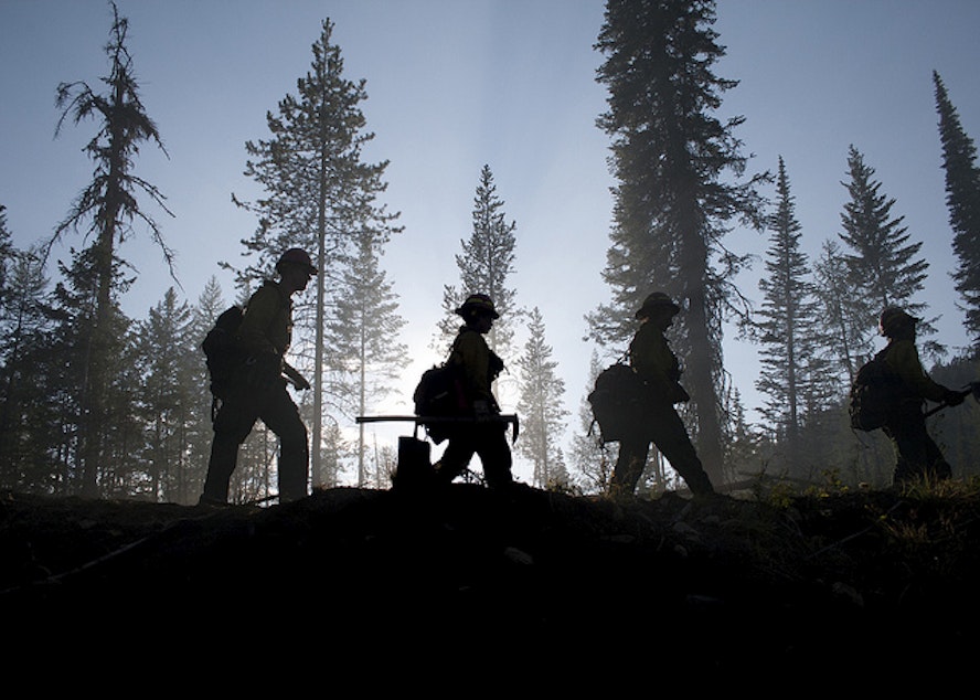 caption: Firefighters battling a wildfire in Washington last year.