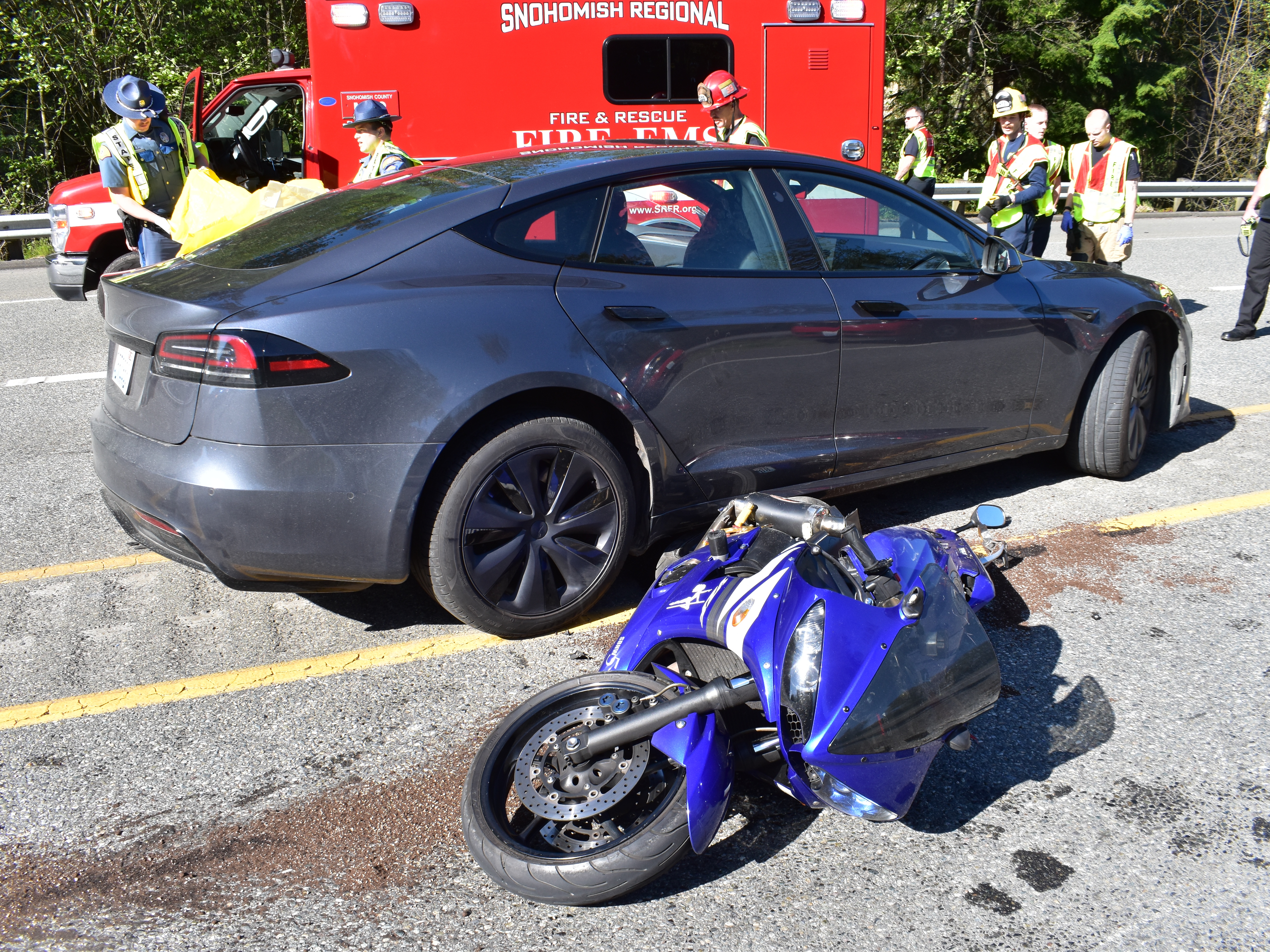 caption: The aftermath of a fatal collision between a Tesla Model S and a motorcycle last year outside Seattle.