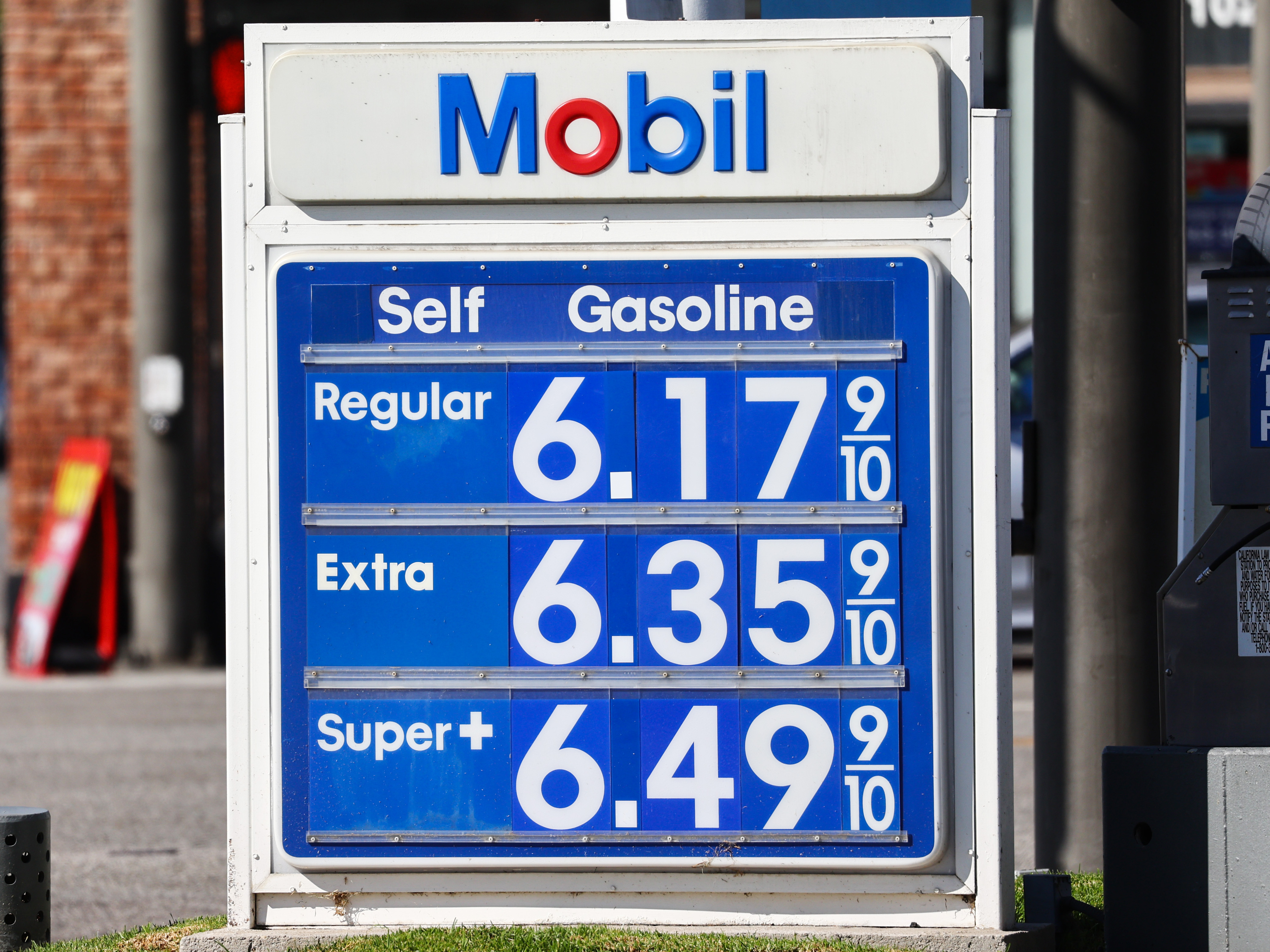 caption: Gas prices are displayed at a Mobil gas station in Los Angeles on Oct. 28, 2022. ExxonMobil posted record earnings in 2022, benefitting from a surge in oil prices.