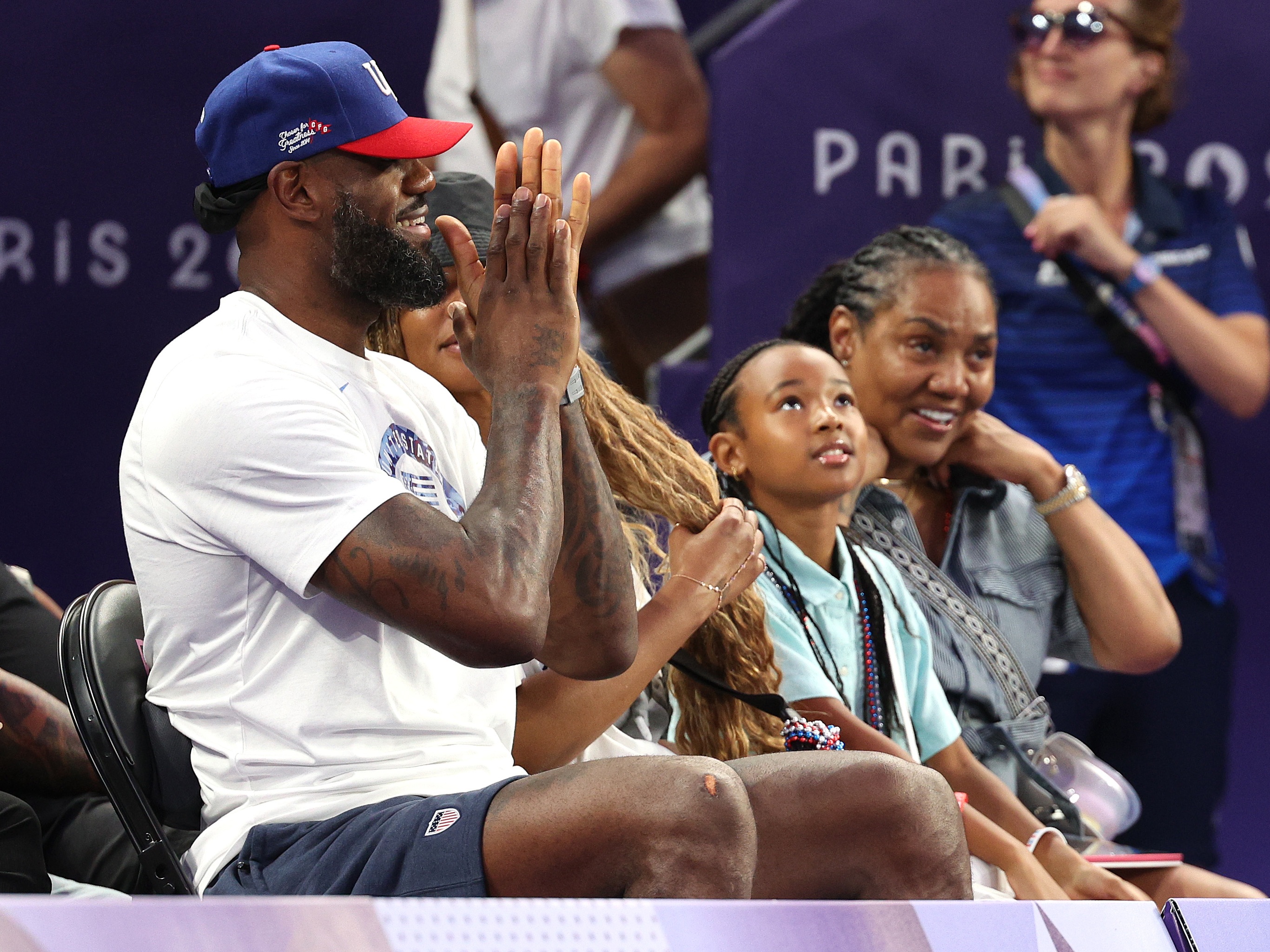 caption: LeBron James cheers on fellow Team USA basketballers in the 3x3 women's game against Spain last week at Esplanade Des Invalides during the Paris Games.