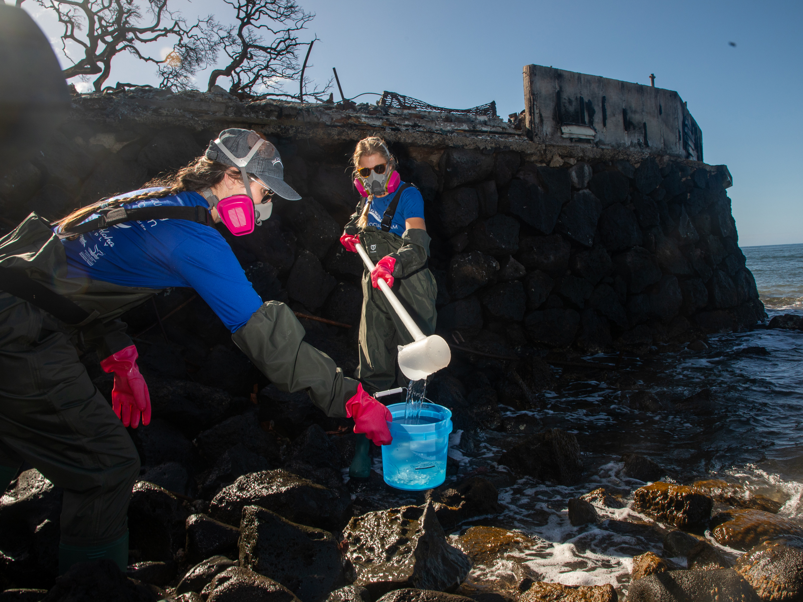 caption: Christiane Keyhani (bottom left) and Liz Yannell (bottom right), of the non-profit group Hui O Ka Wai Ola, measure water quality along Lahaina's coast. The group is part of a coalition that mobilized in the wake of the fire to closely monitor the water quality off Lahaina.