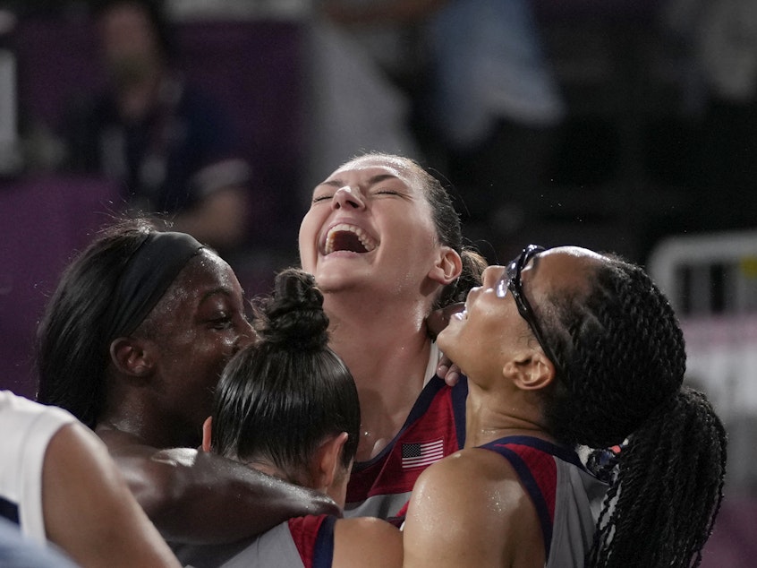 caption: U.S. players Stefanie Dolson, Jacquelyn Young, Kelsey Plum and Allisha Gray celebrate after defeating the team from Russia in the women's 3-on-3 gold medal basketball game at the Summer Olympics on Wednesday.