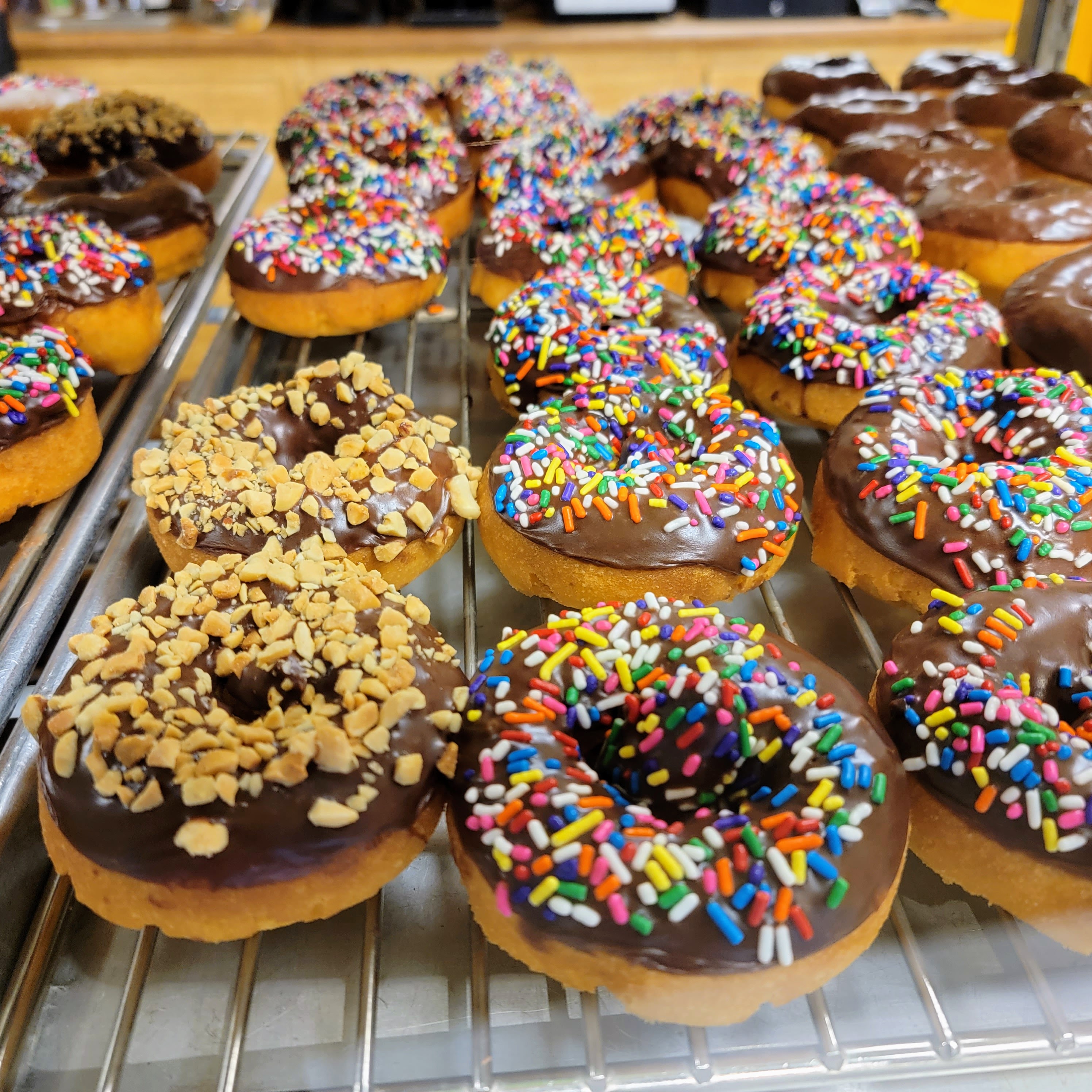 caption: Peanut and sprinkle-covered donuts are as fancy as they get at Kirkland's Countryside Donuts.