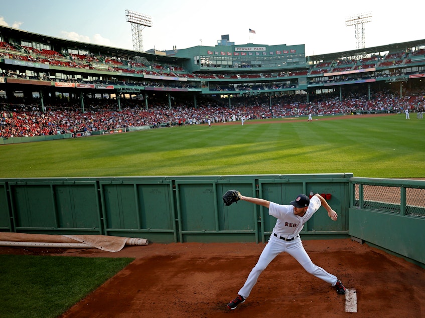 caption: Chris Sale of the Boston Red Sox warms up in the bullpen before a game against the Cleveland Indians at Fenway Park on Aug. 1, 2017.