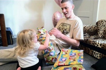 caption: Jeremy Lavender, an Iraq war veteran who struggled with PTSD and traumatic brain injury, at his daughter’s first birthday in 2010. Lavender died after being held at the Chelan County Jail on shoplifting and drug charges seven years later.