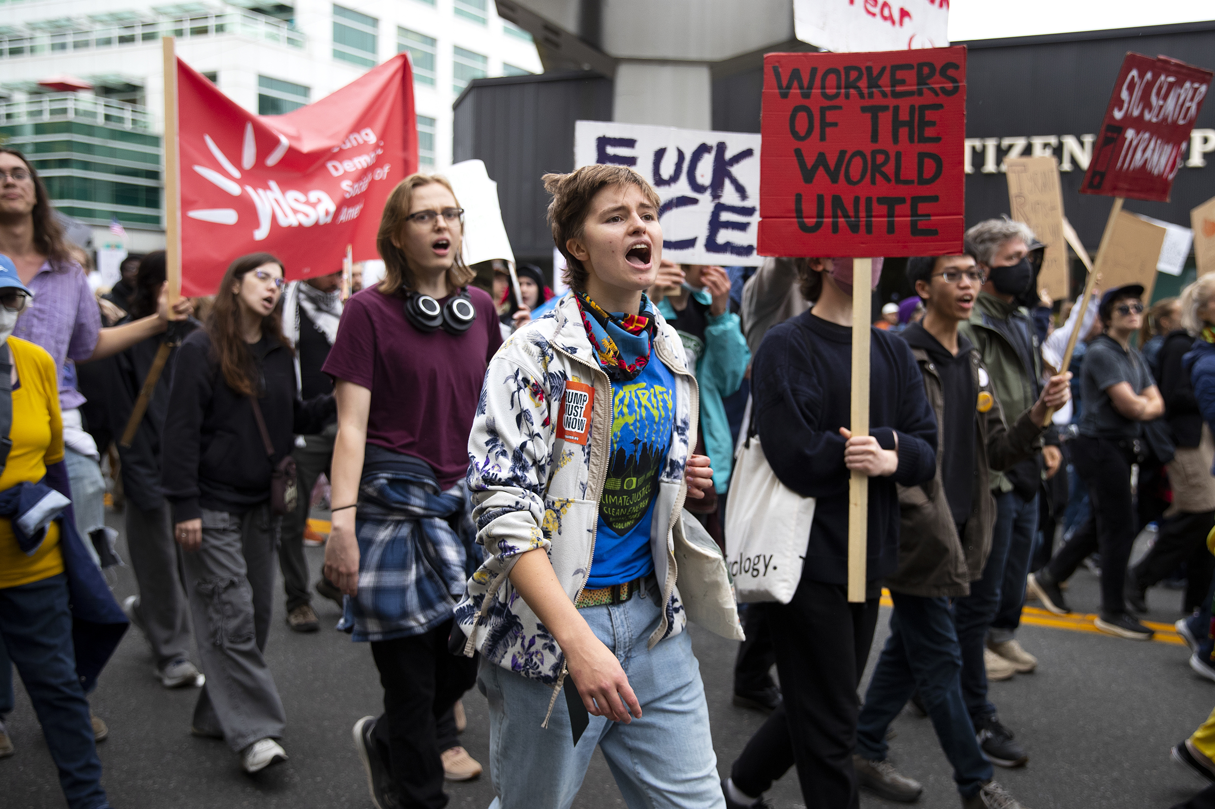 caption: Protesters, including Sevens Baertsch Kovalchick, 18, center, march from Seattle Center following the No Kings rally on Saturday, October 18, 2025, in Seattle.