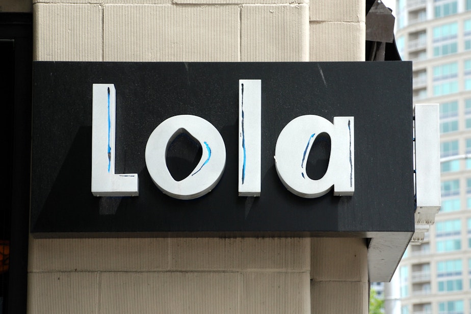 caption: A view from the outside of Tom Douglas' restaurant Lola, now shuttered.