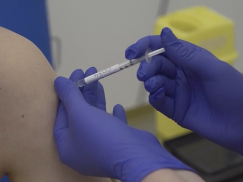 caption: Footage issued by Britain's Oxford University shows a person injected as part of human trials in the U.K. to test a potential coronavirus vaccine last month. Pfizer on Monday began U.S. trials of another vaccine candidate.