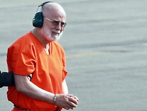 caption: Whitey Bulger is taken from a Coast Guard helicopter to an awaiting Sheriff vehicle after attending federal court in Boston, on June 30, 2011.
