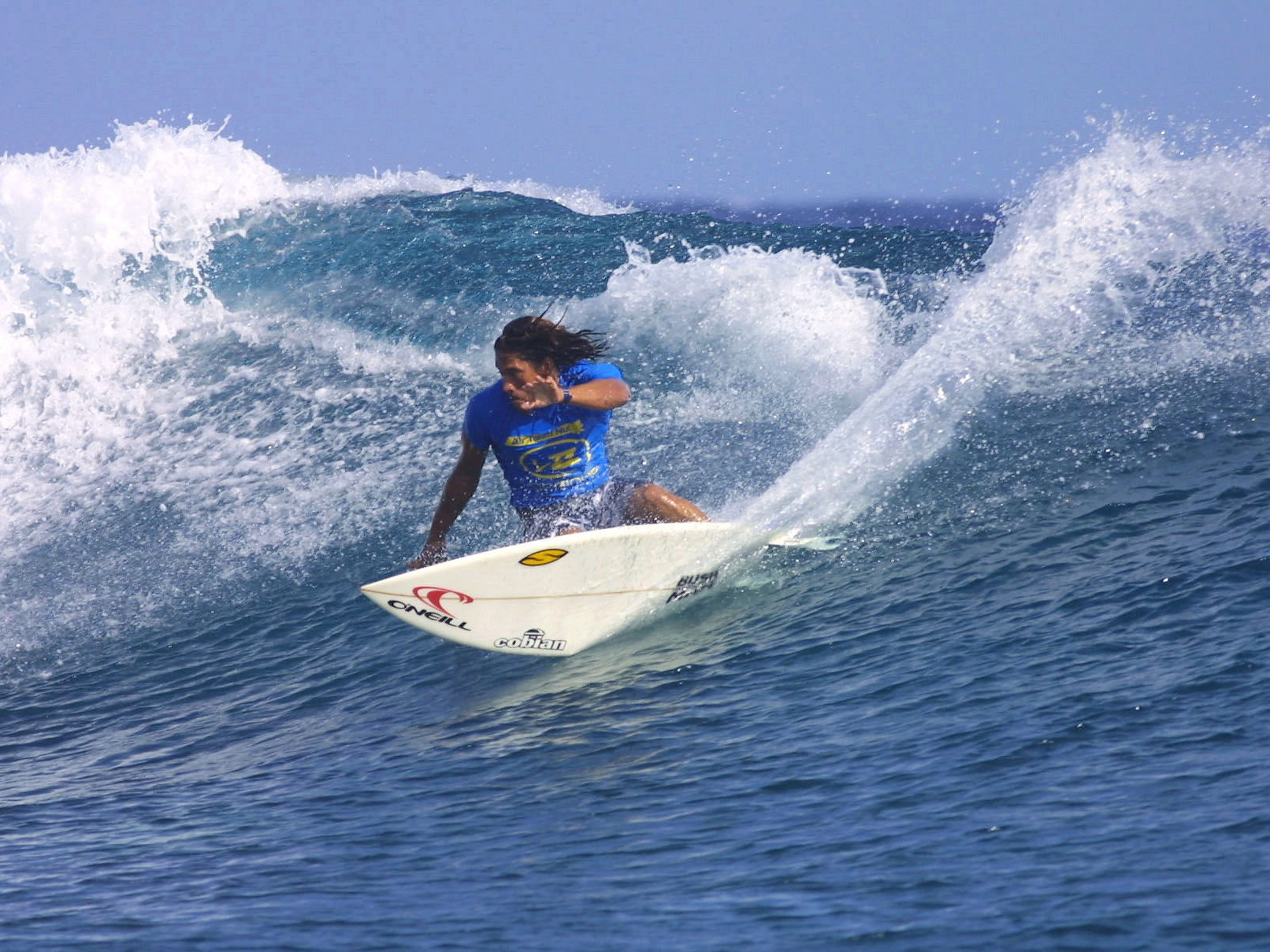 caption: Tamayo Perry during a surf competition at Teahupoo, Tahiti, French Polynesia. Perry died this week from injuries sustained during a shark attack.