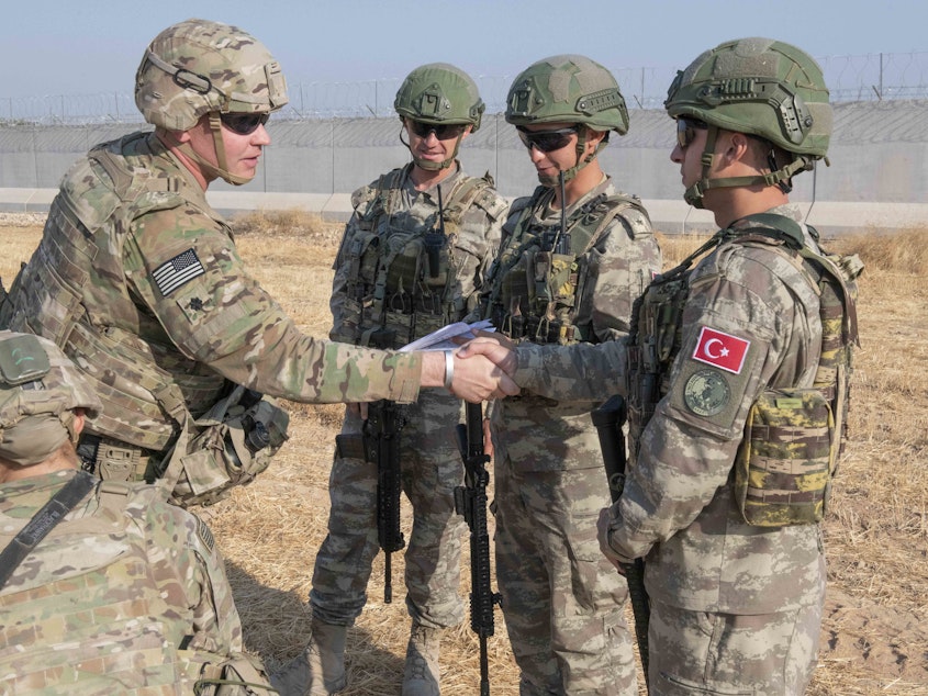 caption: U.S. allies in the Syrian Democratic Forces say the White House's decision to pull troops from the Turkish-Syrian border has left them without hope. Here, a U.S. soldier is seen during a joint patrol with Turkish troops on Friday.