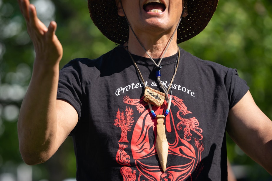 caption: Paul Chiyokten Wagner, a salish sea protector, wears a shirt that reads “protect and restore the Salish Sea," on Saturday, May 22, 2021, at Seattle Center. 
