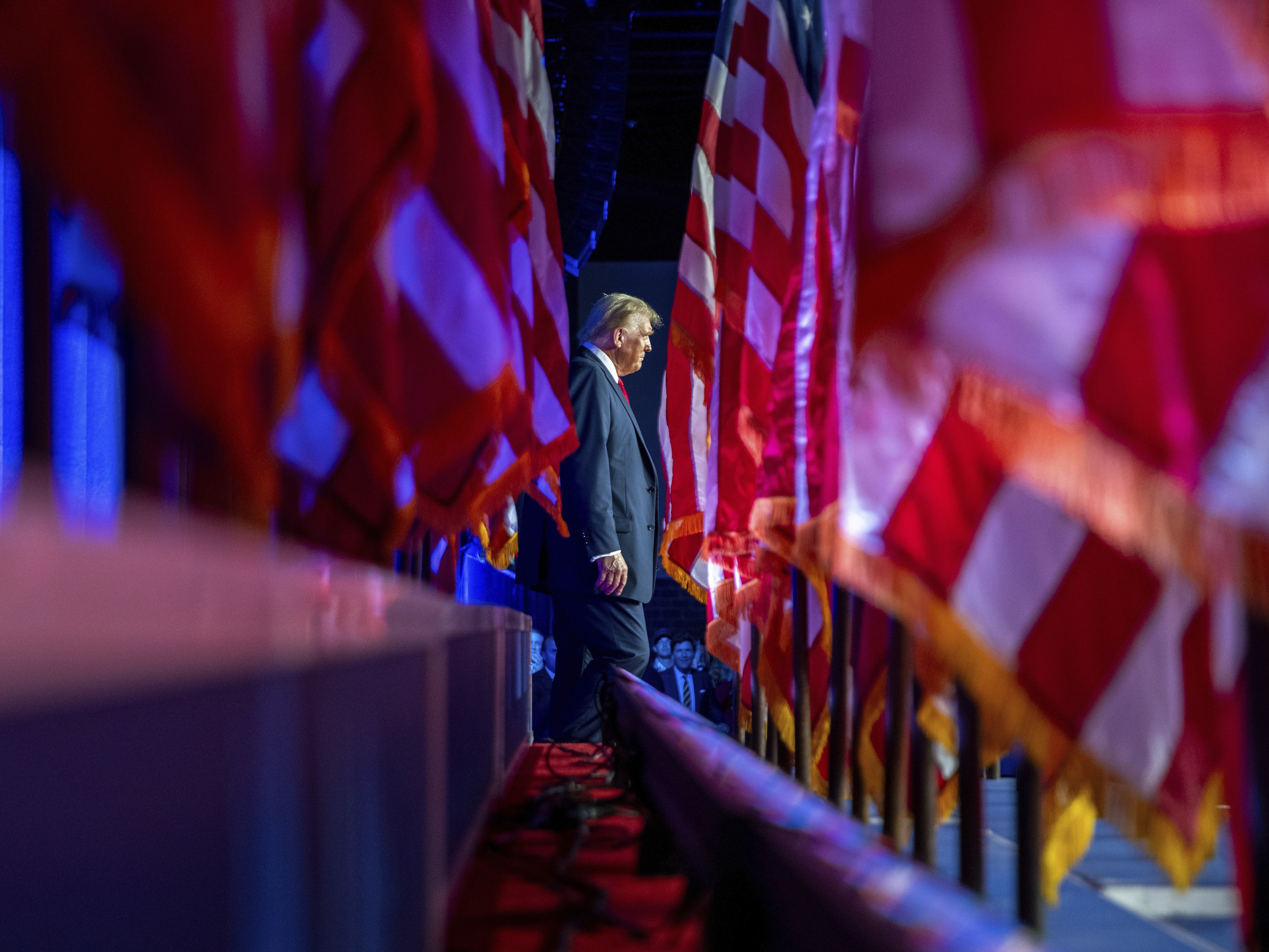 caption: Republican presidential nominee former President Donald Trump arrives at an election night watch party at the Palm Beach Convention Center on Nov. 6, in West Palm Beach, Fla.