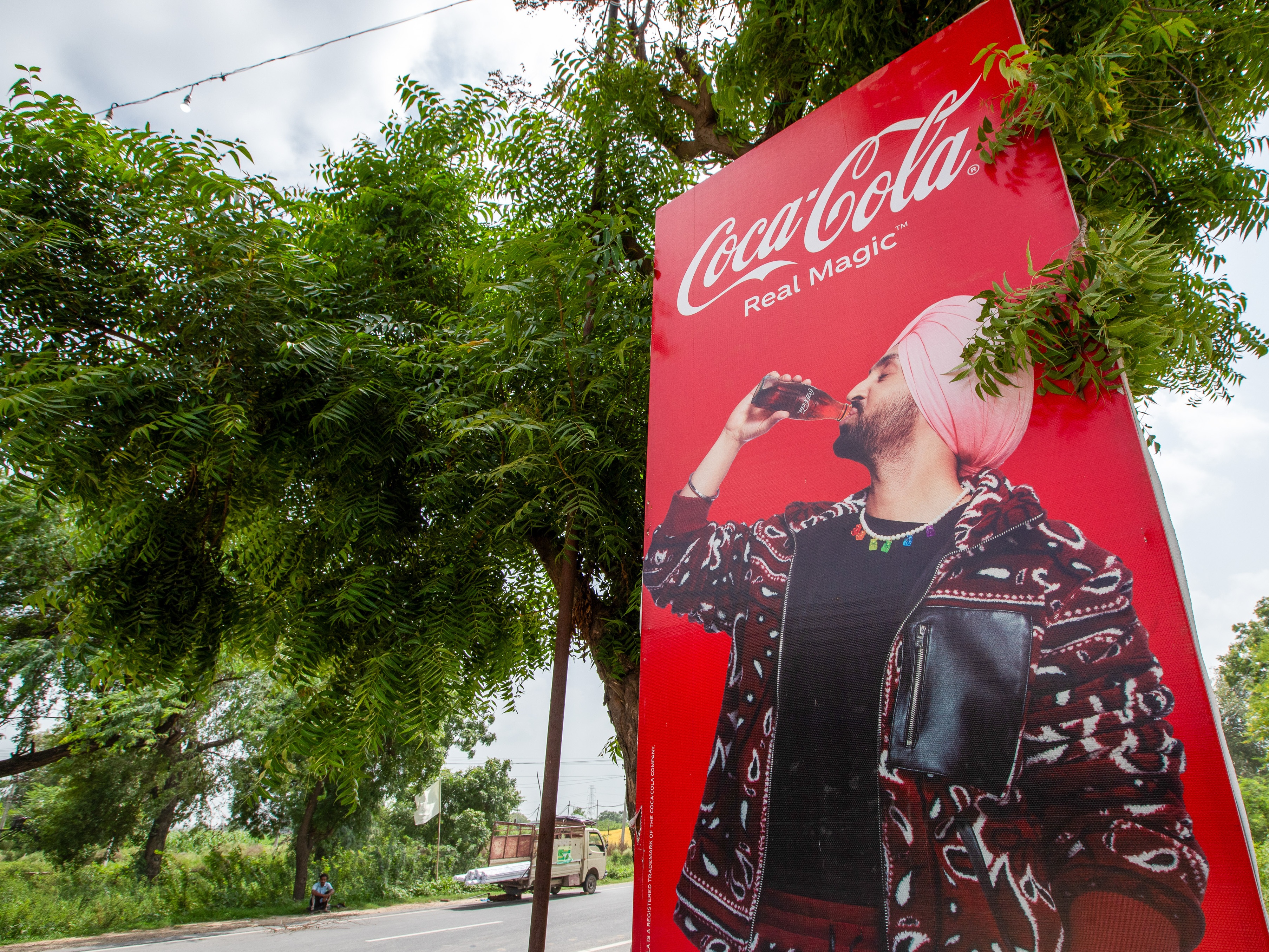 caption: An advertisement of a soft drink brand featuring a local music star in Mansa district, Punjab, India, on Tuesday, Aug. 8, 2023.