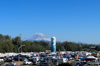 caption: Tahoma, also known as Mt. Rainier, looks over the campers during a weeklong celebration. 