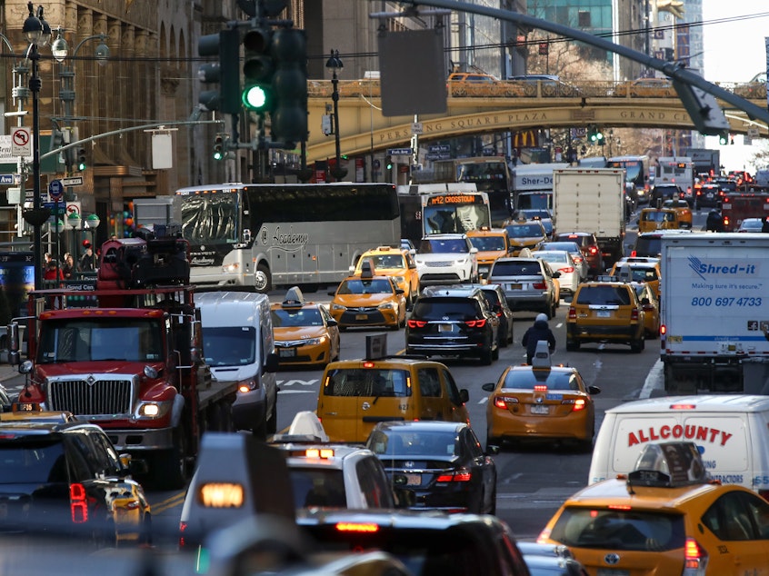 caption: Traffic moves along 42nd Street in Midtown Manhattan on Jan. 25, 2018. After decades of efforts by transportation advocates, the state of New York has approved a plan to add congestion pricing to the city, charging drivers who enter a designated zone of Manhattan.