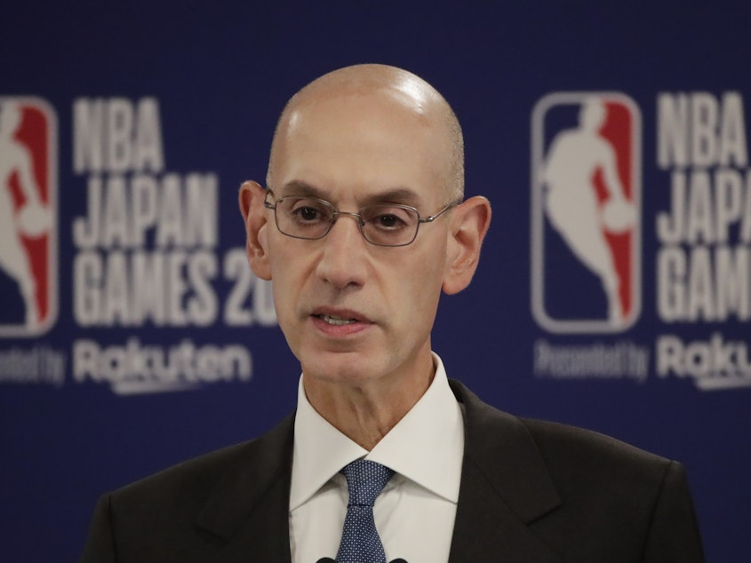 caption: NBA Commissioner Adam Silver speaks at a news conference before an NBA preseason basketball game between the Houston Rockets and the Toronto Raptors Tuesday, in Saitama, near Tokyo.