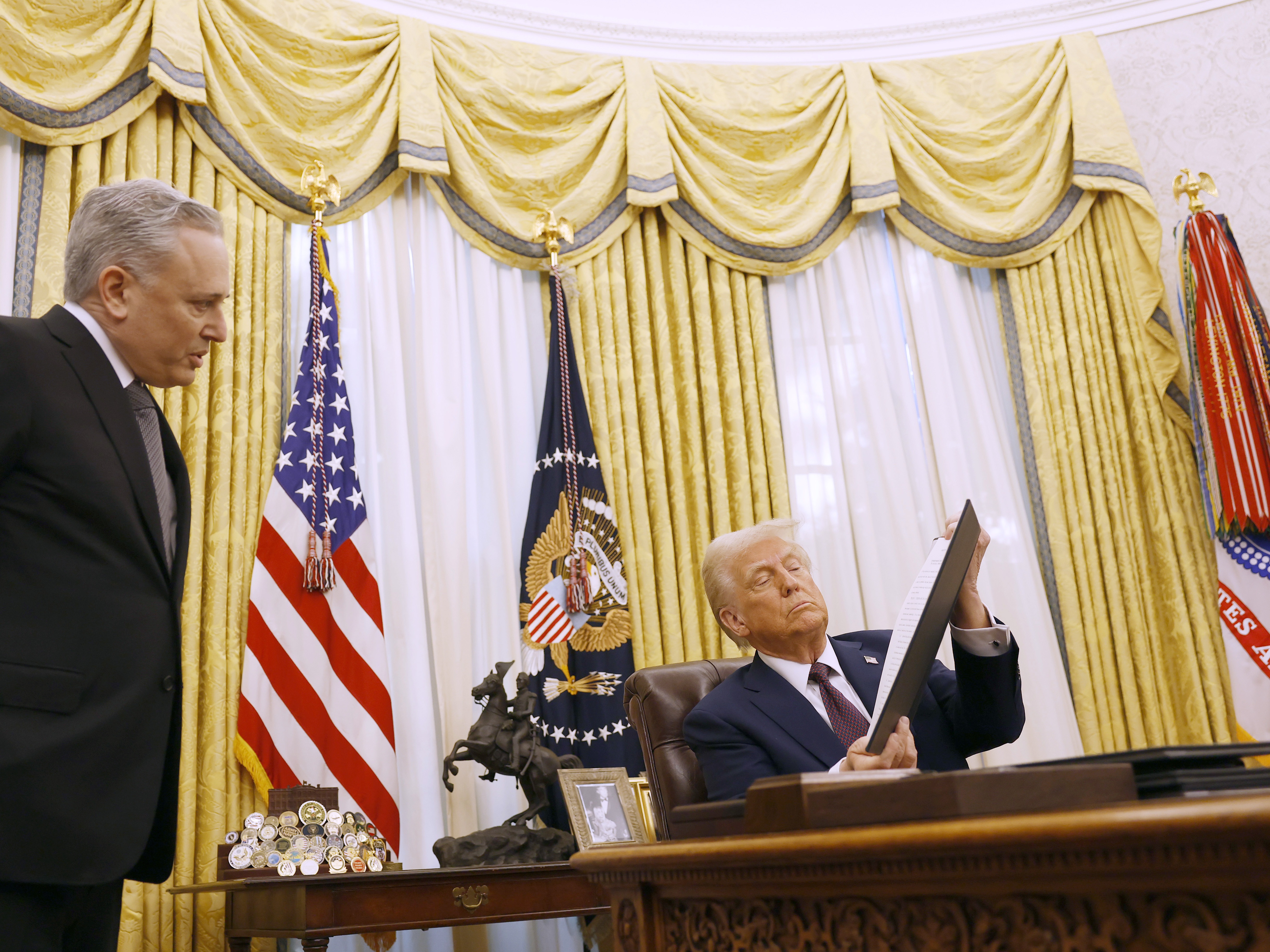 caption: David Sacks, the White House 'czar' for artificial intelligence policy, speaks to President Trump as he signs a series of executive orders in the Oval Office on Jan. 23, 2025.