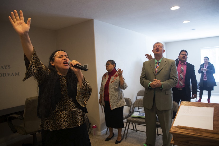 caption: Magdalena Lopez-Muñoz translates a church service in the basement of Nathan Robert's home on Sunday, September 16, 2018, in Des Moines.