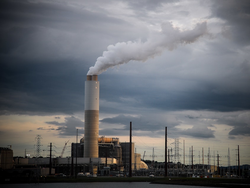 caption: Emissions rise from the Duke Energy Corp. coal-fired Asheville Power Plant in Arden, N.C., in 2018.